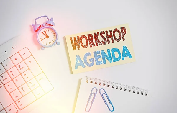 Writing note showing Workshop Agenda. Business photo showcasing helps you to ensure that your place stays on schedule Keyboard with empty note paper and pencil white background.
