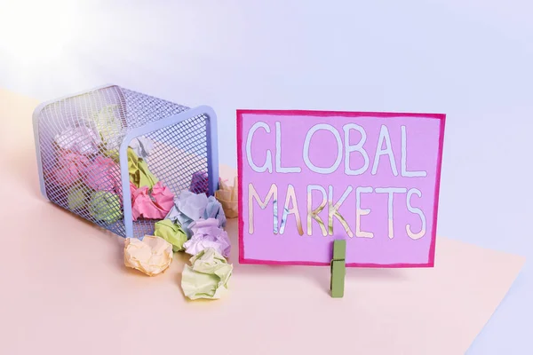 Conceptual hand writing showing Global Markets. Business photo text Trading goods and services in all the countries of the world Trash bin crumpled paper clothespin reminder office supplies.