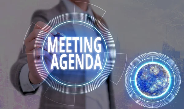 Conceptual hand writing showing Meeting Agenda. Business photo text An agenda sets clear expectations for what needs to a meeting Elements of this image furnished by NASA.