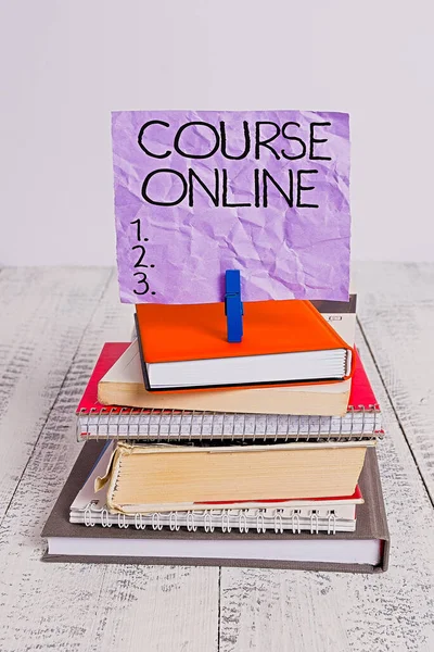 Handwriting text Course Online. Concept meaning eLearning Electronic Education Distant Study Digital Class pile stacked books notebook pin clothespin colored reminder white wooden.