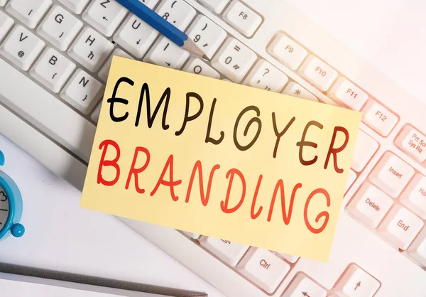 Writing note showing Employer Branding. Business photo showcasing promoting company employer choice to desired target group White pc keyboard note paper and paper clips above white background.