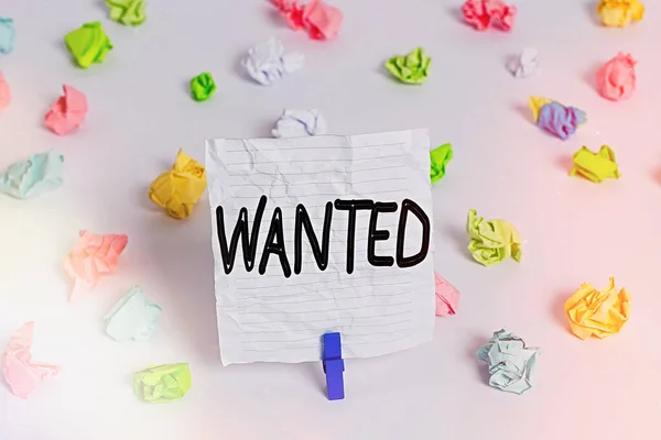 Writing note showing Wanted. Business photo showcasing Desire something Wish want Hoping for Somebody being searched Colored crumpled paper empty reminder white floor clothespin.