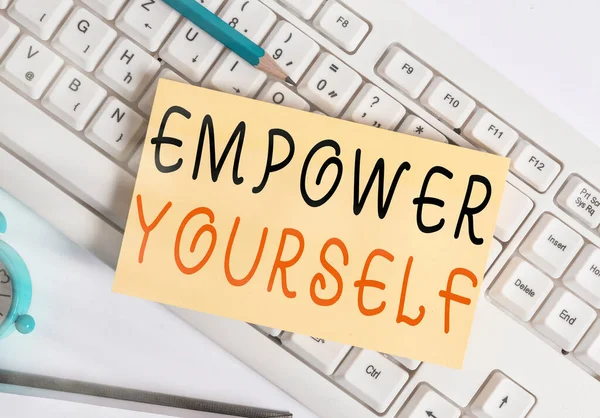 Writing note showing Empower Yourself. Business photo showcasing taking control of our life setting goals and making choices White pc keyboard note paper and paper clips above white background. — Stock Photo, Image