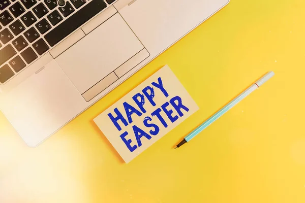 Handwriting text writing Happy Easter. Concept meaning Christian feast commemorating the resurrection of Jesus Trendy silver open laptop square sticky notepad marker colored background.