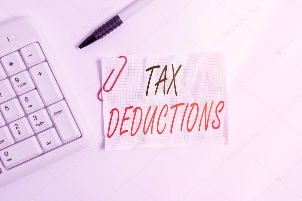 Word writing text Tax Deductions. Business concept for reduction income that is able to be taxed of expenses White pc keyboard with empty note paper above white background.