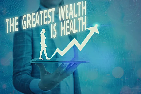 Palavra que escreve texto A maior riqueza é a saúde. Conceito de negócio para Muitos sacrificar seu dinheiro apenas para ser saudável . — Fotografia de Stock
