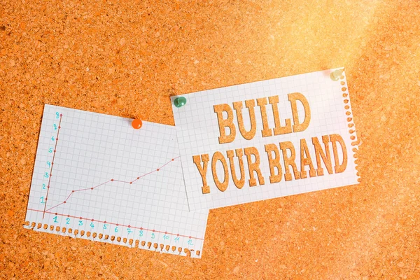 Conceptual hand writing showing Build Your Brand. Business photo showcasing enhancing brand equity using advertising campaigns Corkboard size paper thumbtack sheet billboard notice board. — Stock Photo, Image