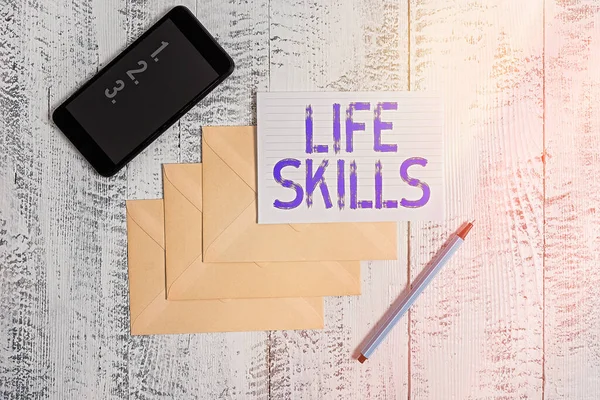 Escritura manual conceptual que muestra habilidades para la vida. Foto de negocios mostrando la habilidad que es necesaria para la plena participación en la vida cotidiana Sobres marcador papel gobernado teléfono inteligente fondo de madera . —  Fotos de Stock