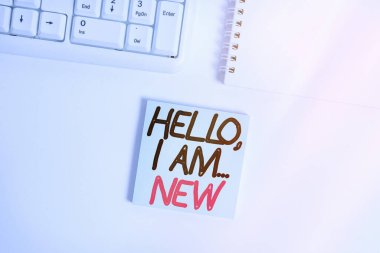 Handwriting text writing Hello I Am New. Concept meaning used greeting or begin telephone conversation Empty note paper on the white background by the pc keyboard with copy space. clipart