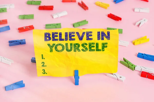 Handwriting text writing Believe In Yourself. Concept meaning common piece of advice that you can do everything Colored clothespin papers empty reminder pink floor background office pin. — Stock Photo, Image