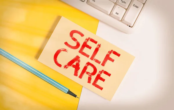 Conceptual hand writing showing Self Care. Business photo text the practice of taking action to improve one s is own health Paper with copy space and keyboard above orange background table. — Stock Photo, Image