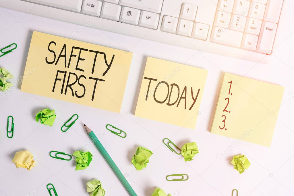 Word writing text Safety First. Business concept for used to say that the most important thing is to be safe Flat lay above blank copy space sticky notes with business concept.