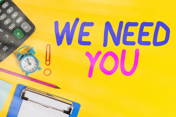Text sign showing We Need You. Conceptual photo asking someone to work together for certain job or target Clock clips crushed note calculator pencil clipboard band color background.