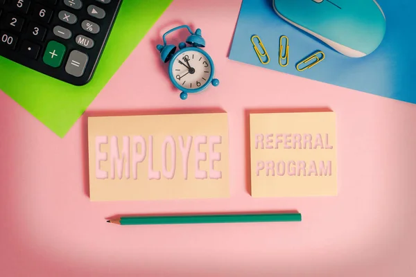 Handwriting text Employee Referral Program. Concept meaning employees are rewarded for introducing recruits Wire mouse clock calculator notepads marker sheets clips color background.