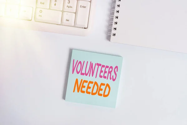 Handwriting text writing Volunteers Needed. Concept meaning need work or help for organization without being paid Empty note paper on the white background by the pc keyboard with copy space. — Stock Photo, Image