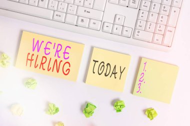 Yeniden işe aldığımızı gösteren kavramsal el yazısı. Uygulamaları incelemek ve aday bulmak için iş fotoğrafı metni süreci boş fotokopi alanı yapışkan notların üzerinde iş konsepti ile yatıyordu.