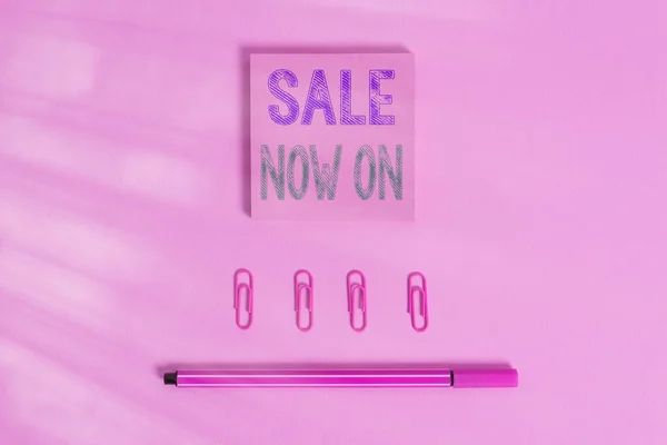 Word writing text Sale Now On. Business concept for Discounts and promotional sales retail marketing offer Colored blank sticky note clips binders gathered pen trendy cool background.