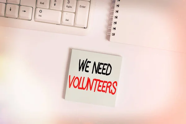 Handwriting text writing We Need Volunteers. Concept meaning someone who does work without being paid for it Empty note paper on the white background by the pc keyboard with copy space. — Stock Photo, Image