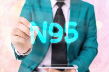 Kelime yazma metni N95. Giyen kişiyi korumak için bireysel koruyucu ekipmanlar için iş konsepti.