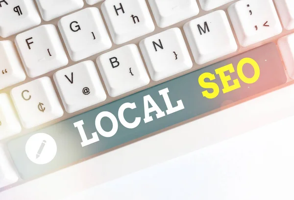 Writing note showing Local Seo. Business photo showcasing helps businesses promote products and services to local customers. — Stock Photo, Image