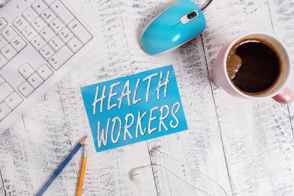 Word writing text Health Workers. Business concept for whose job to protect the health of their communities technological devices colored reminder paper office supplies keyboard mouse.