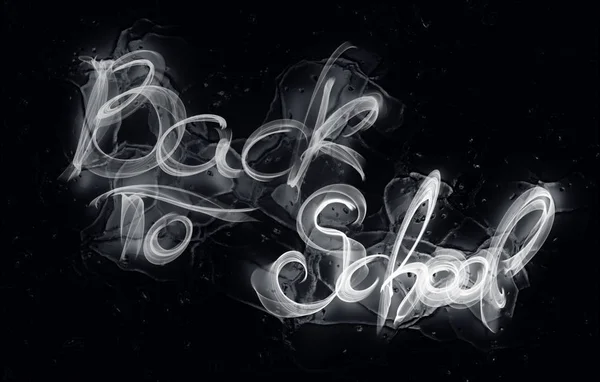 Back to school words lettering made by white fire or flame over black ice reflection background — 스톡 사진