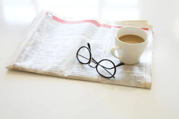 Newspaper with coffee on table — Stock Photo, Image