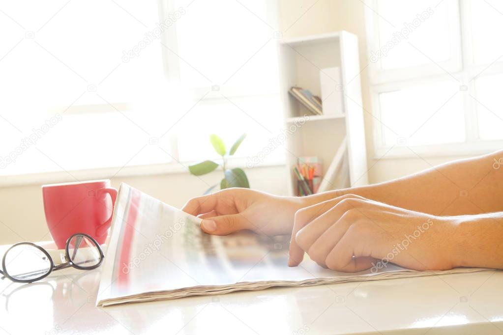 Man hands reading newspaper