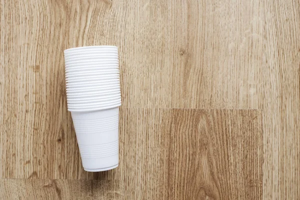 Set of plastic cups on wooden background