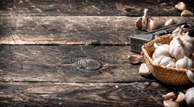 Güzel kokulu sarımsak basın aracı. Eski ahşap masa üzerinde.