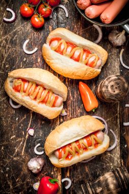 Street food. Fresh hot dogs with peppers, onions and tomatoes. clipart