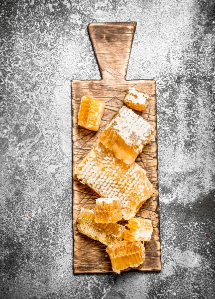 Honey background. Fresh honeycomb on the Board.
