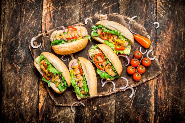Street food. hot Dogs with herbs, vegetables and hot mustard.