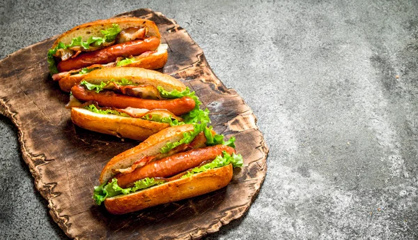 Fast food menu. Hot dogs beef barbecue with bacon and herbs.