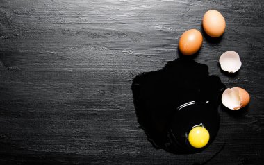 Kırık yumurta. Siyah ahşap arka plan üzerine.