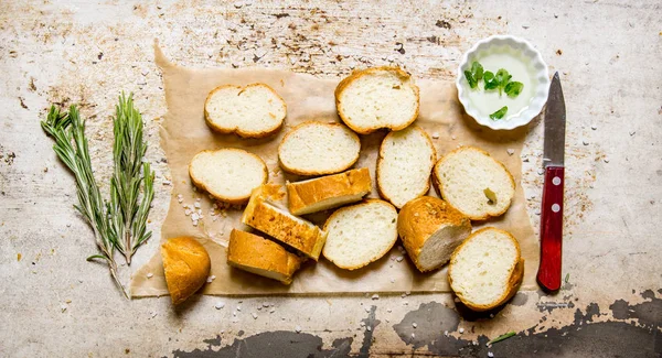 Ciabatta with herbs on paper. On rustic background. — Stock Photo, Image