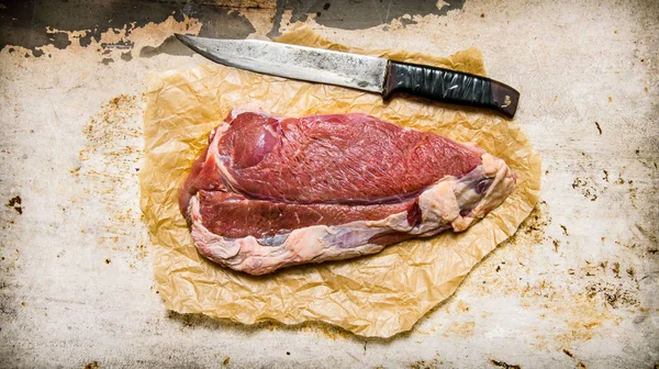 Carne fresca cruda con cuchillo de carnicero . — Foto de Stock