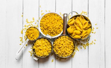 Farklı türlerde tencerede kuru makarna . 