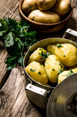 Ahşap masa üzerinde otlar ile haşlanmış patates . 