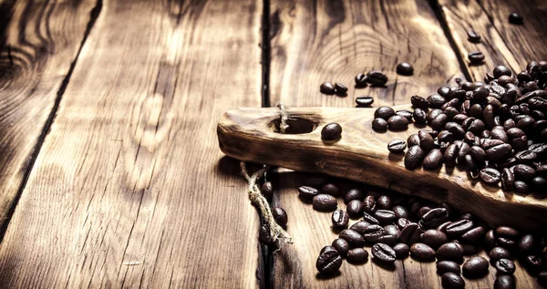 Frische aromatische Kaffeebohnen auf einem Holzbrett. — Stockfoto