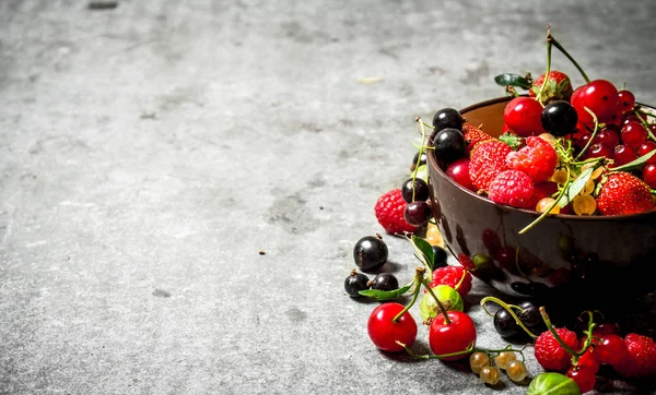 Berries in a Cup. On stone table.
