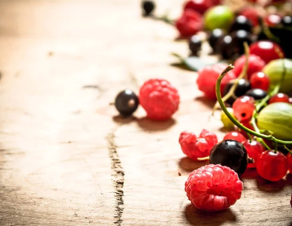 Fresh forest berries .On wooden background.