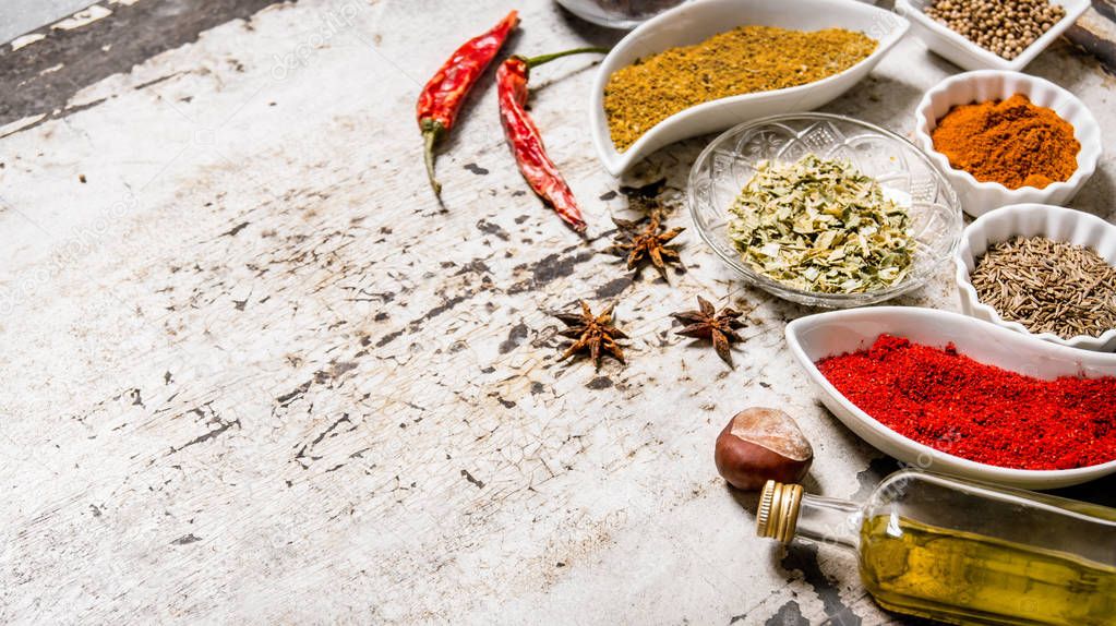 Large set of spices and herbs in the cups. 