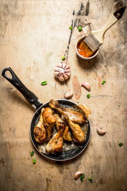 Baharatlı tavuk budu sarımsak ve domates sos ile.