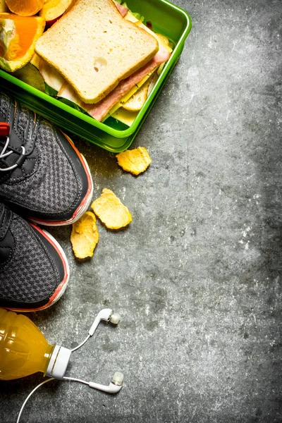 Sandviç, portakal suyu ve meyve. Taş masanın üzerine.