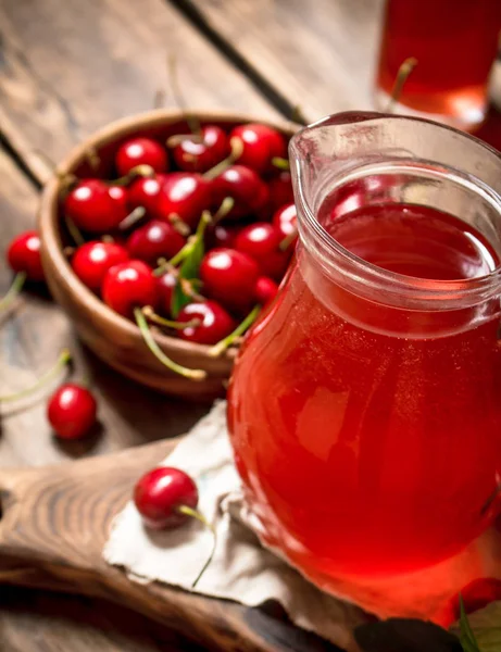 Fresh cherry juice .On wooden background. — Stock Photo, Image