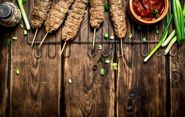 Kebab with tomato sauce and green onions. — Stock Photo, Image