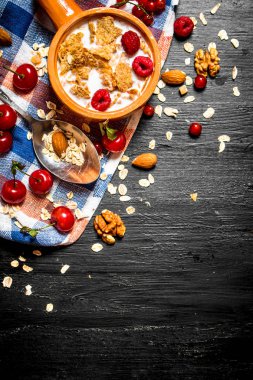 Meyveler, fındık ve kabın içinde süt ile müsli.