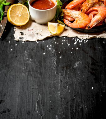 Eski kumaş üzerine domates soslu karides.