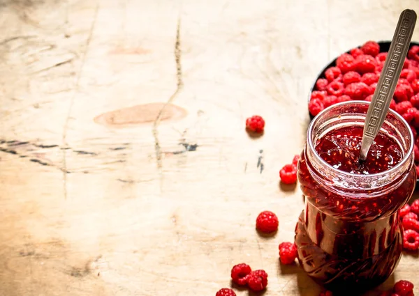 Sweet raspberry jam in jar with spoon. — Stock Photo, Image